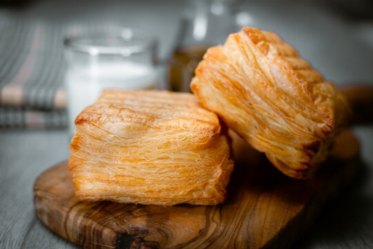 Bakery shop products - various kinds of baguette, bagel, donut, croissant, rolls, bread, puff pastry, powdered sugar delicious pies. Neutral background. Food from bakeries.
