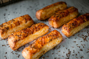 Bakery shop products - various kinds of baguette, bagel, donut, croissant, rolls, bread, puff pastry, powdered sugar delicious pies. Neutral background. Food from bakeries.