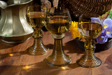 Antique German glassware, old Dutch style rummer or roemer glasses with white wine and flowers