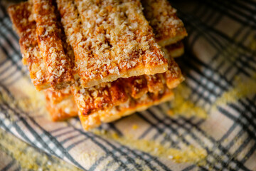 Bakery shop products - various kinds of baguette, bagel, donut, croissant, rolls, bread, puff pastry, powdered sugar delicious pies. Neutral background. Food from bakeries.