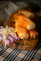 Bakery shop products - various kinds of baguette, bagel, donut, croissant, rolls, bread, puff pastry, powdered sugar delicious pies. Neutral background. Food from bakeries.