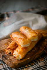 Bakery shop products - various kinds of baguette, bagel, donut, croissant, rolls, bread, puff pastry, powdered sugar delicious pies. Neutral background. Food from bakeries.