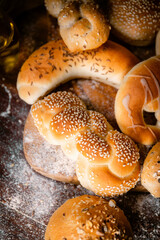 Bakery shop products - various kinds of baguette, bagel, donut, croissant, rolls, bread, puff pastry, powdered sugar delicious pies. Neutral background. Food from bakeries.