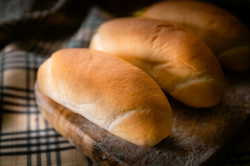 Bakery shop products - various kinds of baguette, bagel, donut, croissant, rolls, bread, puff pastry, powdered sugar delicious pies. Neutral background. Food from bakeries.