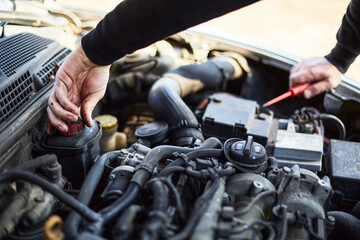 Men hands checking car engine