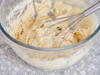 A gluten-free pie dough in a glass bowl with a whisk
