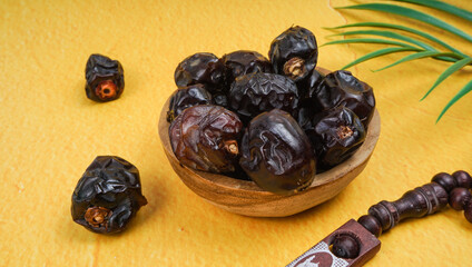 Kurma Ajwa, Ajwa Dates. Served in wooden bowl. Ramadan kareem fasting month concept