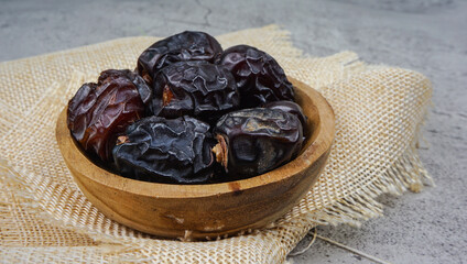 Kurma Ajwa, Ajwa Dates. Served in wooden bowl. Ramadan kareem fasting month concept