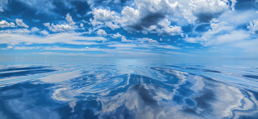 Fototapeta na wymiar Cumulus clouds reflected on smooth, calm water