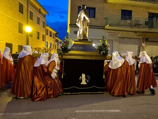 Soria, Spain - April 11, 2022: Holy Monday procession of the Soria brotherhood through the streets at dusk