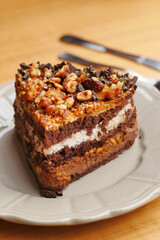 chocolate and cream cake on a plate on table 