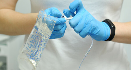 saline gloves dentistry The nurse collects the saline solution of sodium chloride from bottle into...