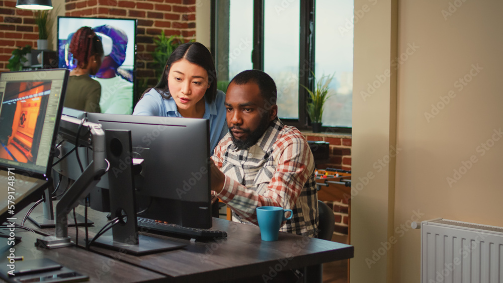 Poster creative agency employees using computers to develop new graphics interface in office, doing teamwor