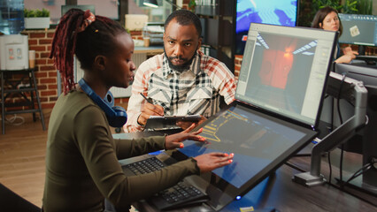 Software company workers team brainstorming game design ideas, looking at artistic development software. Creative agency colleagues analyzing CGI technique to create 3D modern project.