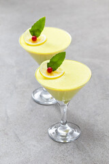 Vegan Lemon cream dessert, Panna Cotta in a martini glass. Light gray background
