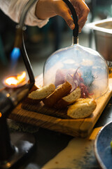 Smoked salmon on a wooden board with toasts and salad. Haute cuisine. fine dining cuisine.