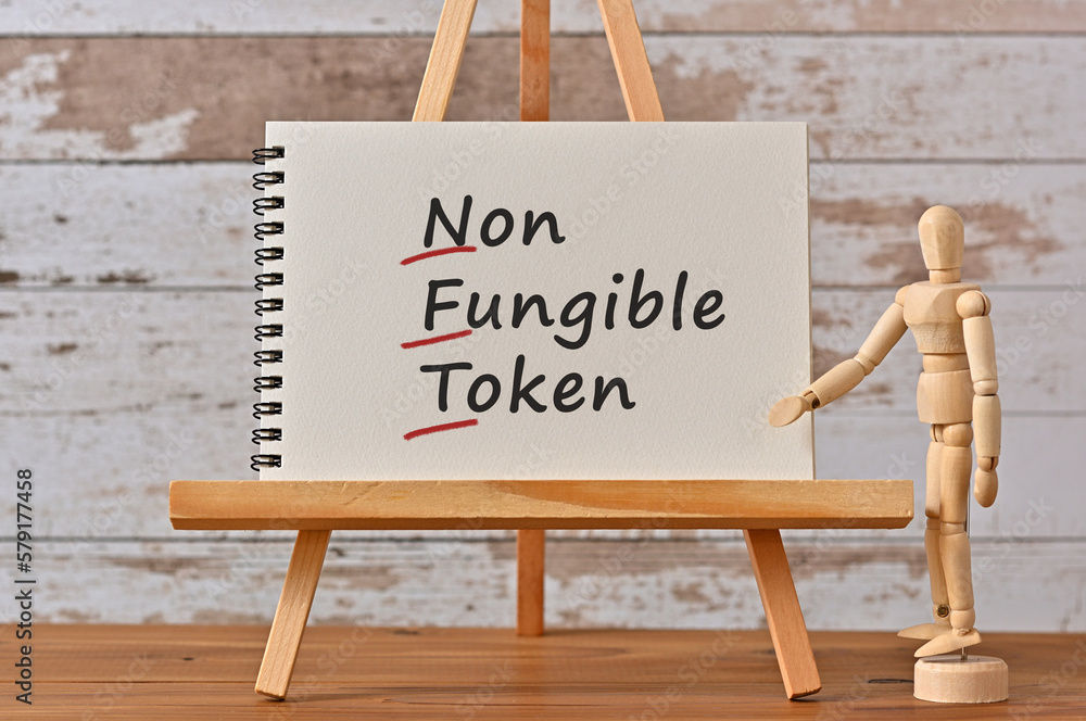 Poster there is notebook with the word non-fungible token. it is an eye-catching image.