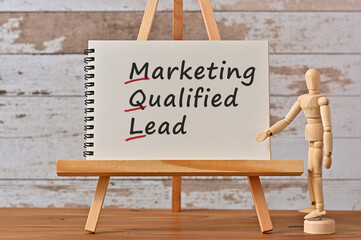 There is notebook with the word Marketing Qualified Lead. It is an eye-catching image.