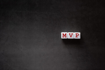 There is white cube with the word MVP. It is an abbreviation for Minimum Viable Product as...