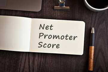 There is notebook with the word Net Promoter Score. It is an eye-catching image.