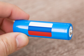 Flag of russia on rechargeable li-ion battery. Concept of producing batteries in russia