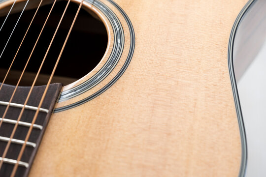 detail of the sound hole of a wood acoustic guitar, light wood, spruce wood, copy space, selective focus