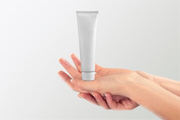 Woman hand hold cream product.