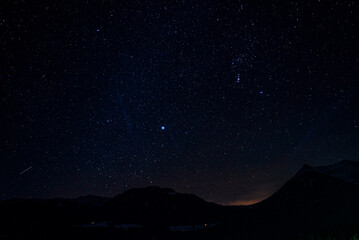 Scenic view of beautiful sky with stars glowing over silhouette mountain and landscape at night