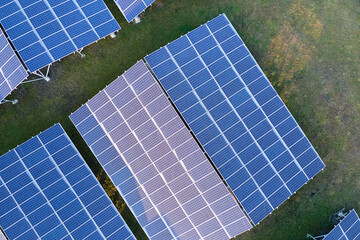 Aerial view of large sustainable electrical power plant with rows of solar photovoltaic panels for producing clean ecological electric energy. Renewable electricity with zero emission concept.