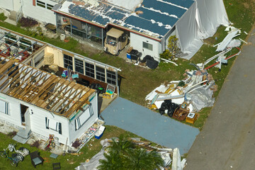 Badly damaged mobile homes after hurricane Ian in Florida residential area. Consequences of natural...