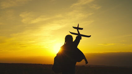 child girl aircraft pilot. kid child wants be able fly. children run with airplane sunset....