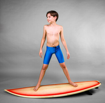 Young Boy Pretending To Ride On A Surfboard