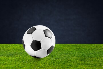 Official Football Ball on green grass at stadium