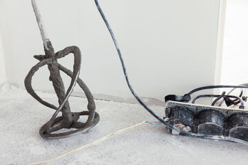 Fototapeta na wymiar Power mixer on floor near wall indoors. Tiles installation process