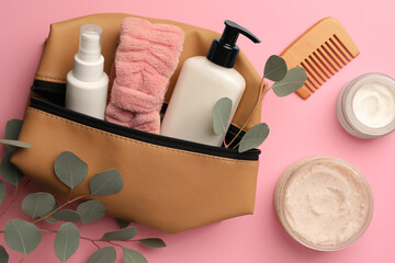 Preparation for spa. Compact toiletry bag with different cosmetic products, comb and eucalyptus on...