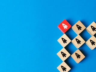 Wooden cubes with spaceship symbol. Unlocking the power of leadership, strategies for success.