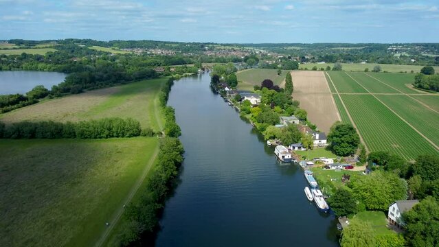 Smooth 4k drone footage flying over the river Thames from Marlow towards Bourne End Buckinghamshire UK