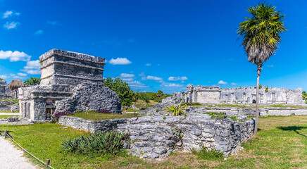 A view across palaces and temple ruins at the Mayan settlement of Tulum, Mexico on a sunny day