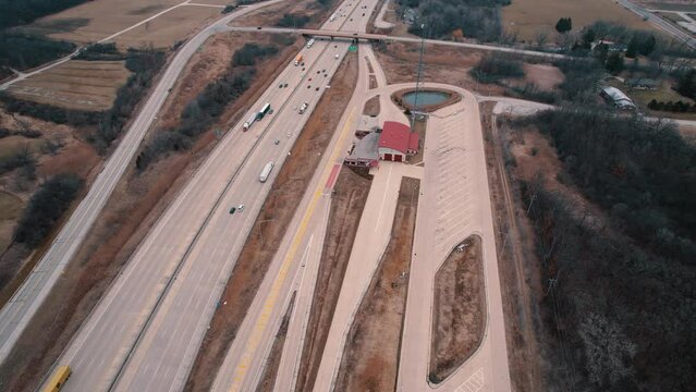 Aerial of Truck Weigh Station next to Interstate. Department of Trasportation place where they pull truck drivers for safety inspection. Scale for vehicles. Wisconsin, USA 4k