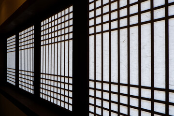 Wooden window of asian traditional architecture. Dark and red brown Door of Korean traditional with traditional pattern. Asian traditional interior design.