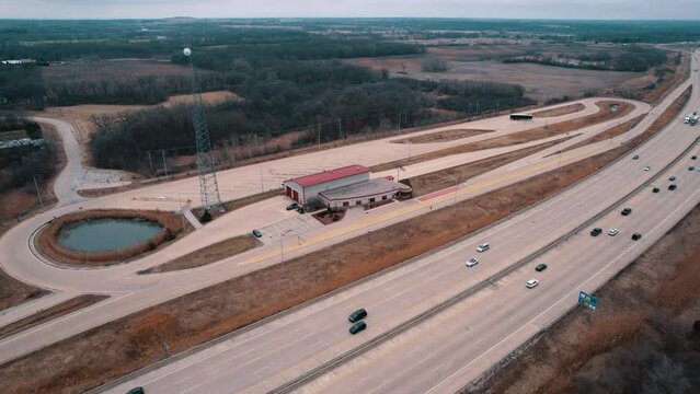 Commercial Trucks driving next to a closed Weigh Station. Department of Trasportation place where they pull truck drivers for safety inspection. Scale for vehicles. Wisconsin, USA 4k