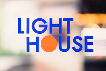 The text LIGHT HOME on the background uses a light effect