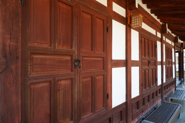Wooden door  and wall of asian traditional architecture. Dark and  brown window  with oriental traditional pattern. Asian traditional interior design.