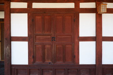 Wooden old door  and wall of asian traditional architecture. Dark and brown  door  with oriental...