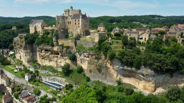 Smooth 4K aerial footage of Beynac-et-Cazenac, a beautiful hillside village located in the Dordogne department in southwestern France