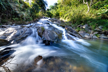 Fototapeta na wymiar Tourists to admire the majestic beauty of Dau Dang waterfall in Bac Kan province, Vietnam
