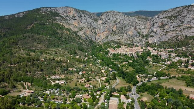 Smooth 4K footage of Moustiers-Sainte-Marie or Moustiers, a village perched on terraces on the side of a limestone cliff in the Alpes-de-Haute-Provence department in the Provence-Alpes-Côte d'Azur.
