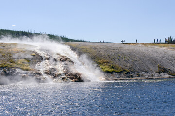 Majestic geyser eruption in Yellowstone National Park witnessed by visitors