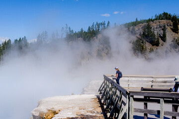 Majestic geyser eruption in Yellowstone National Park witnessed by visitors