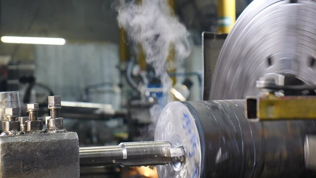 Metal drilling process at modern manufacturing plant. Drilling tool piercing deep hole in big metal part of turbine. Drilling through metal product with mechanical tool at factory. 4 k video